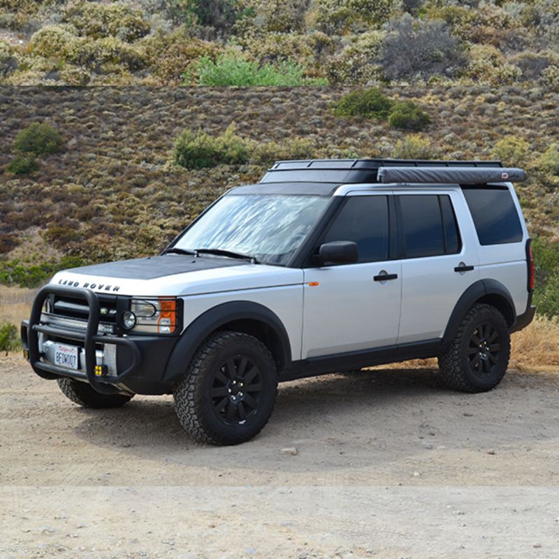 Badass Tents "CONVOY" Land Rover 05-16 LR3  / LR4 Rooftop Tent - PRE-ASSEMBLED. Front Side view of closed tent on vehicle at campsite