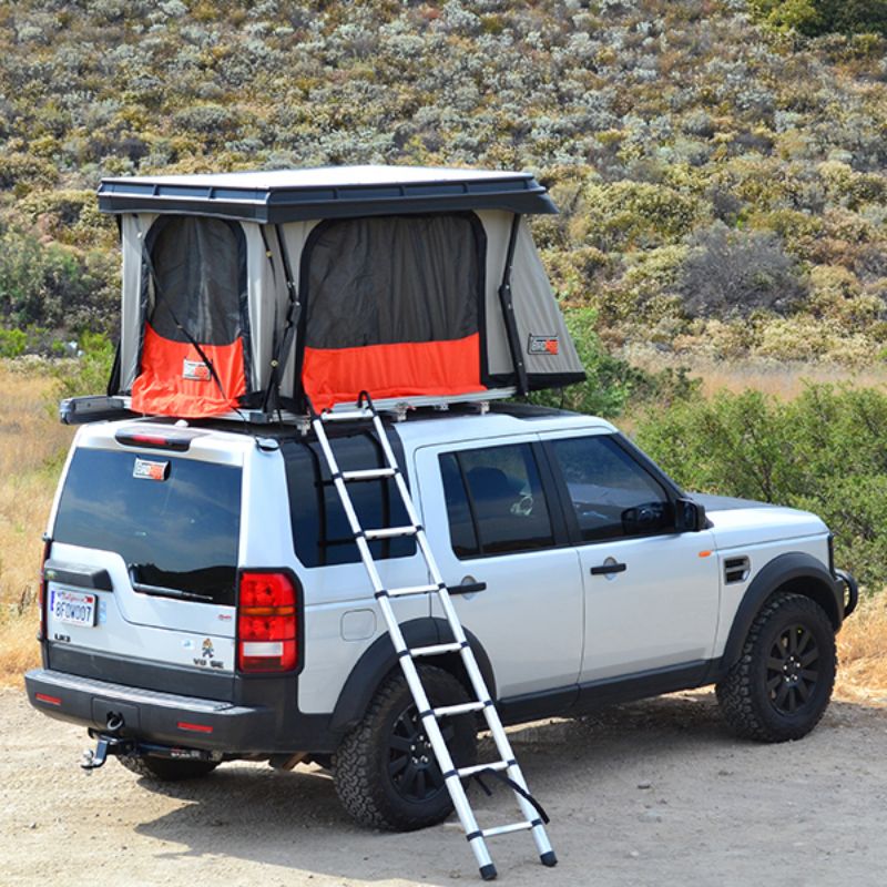 Badass Tents "CONVOY" Land Rover 05-16 LR3  / LR4 Rooftop Tent - PRE-ASSEMBLED. Rear corner view of Open tent on vehicle with ladder at campsite
