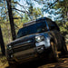 Badass Tents "CONVOY" 2020-23 Land Rover NEW Defender 110 Rooftop Tent PRE-ASSEMBLED. Front view of closed tent on vehicle on trail