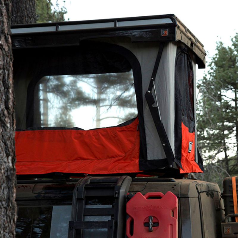 Badass Tents "CONVOY" 2020-23 Land Rover NEW Defender 110 Rooftop Tent PRE-ASSEMBLED. Close up Side view of open tent on vehicle at campsite 