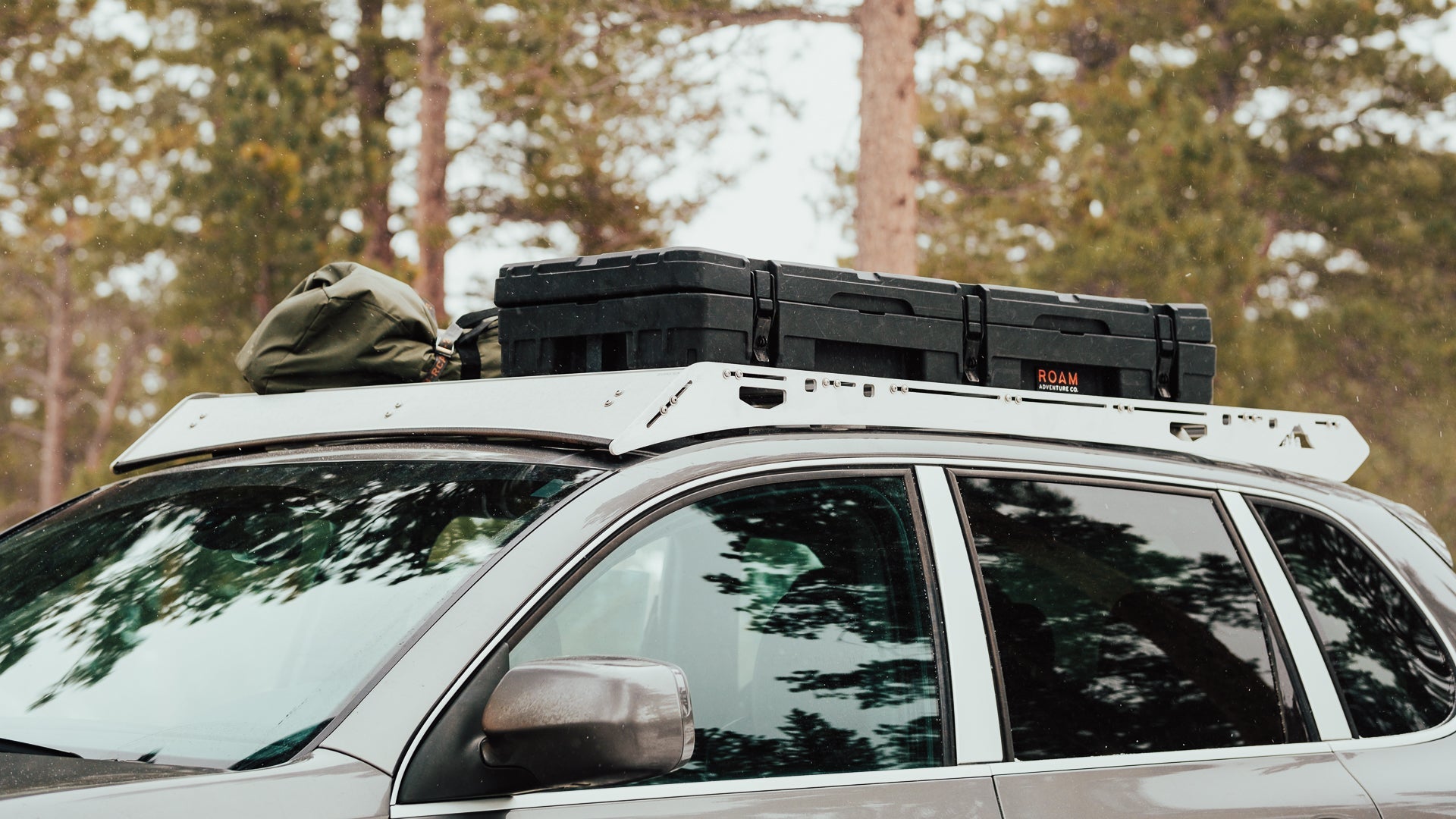 Porsche Cayenne Roof Rack Front corner view of rack with equipment on vehicle outside