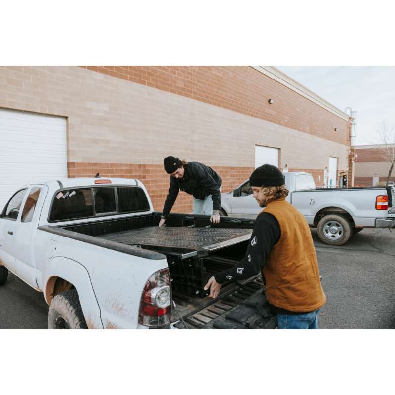 DECKED Truck Bed Drawer System for Jeep Gladiator two men installing system  in truck outdoors