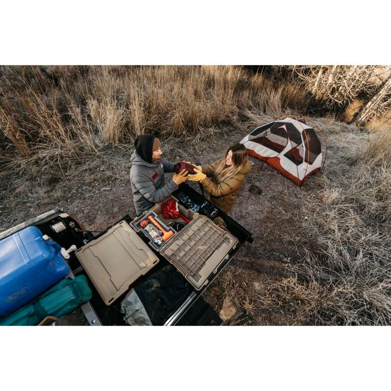 DECKED Truck Bed Drawer System for Nissan Trucks top view of open drawer with bins installed at campsite with people