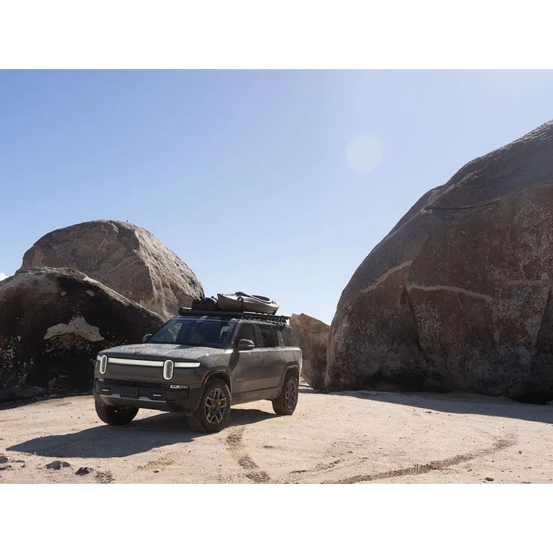 Front Runner Slimline II Rivian R1S riding through rocks