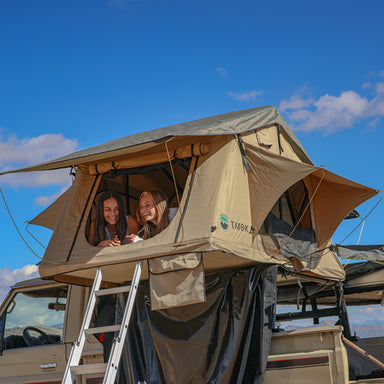 Overland Vehicle Systems 3+ Person TMBK Roof Top Tent People in open tent with ladder outside