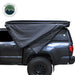 Overland Vehicle Systems XD Nomadic 270 Degree Awning & Wall Kit Combo with Lights, Black Out, Black Body , Trim, And Travel Cover partially opened side view  on white background