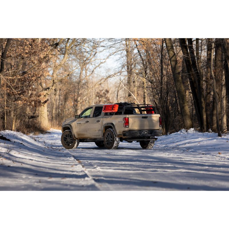 Chevy Colorado SHIPROCK Mid Rack System MIDRACK TUWA PRO®️ rear corner view installed on vehicle on snowy road