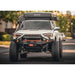 Backwoods Adventure Mods Hi-Lite Overland Front Bumper [PreRunner Bull Bar] for Toyota 4Runner (5th Gen) Front view of bumper attached to vehicle with camper on road