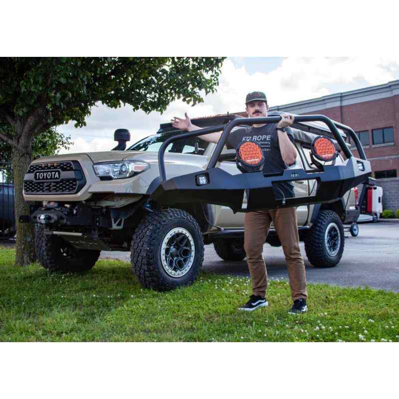 Backwoods Adventure Mods Hi-Lite Overland Front Bumper [Bull Bar] for Toyota Tacoma (3rd Gen) Person holding bumper next to vehicle