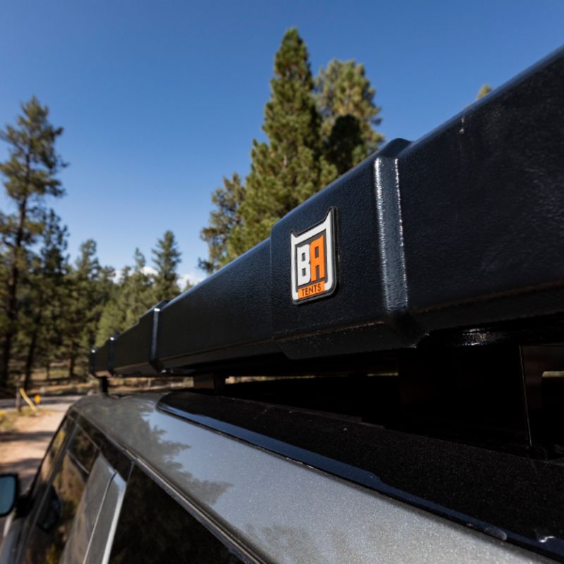 Badass Tents "RUGGED" Rooftop Tent (Universal Fit).Close up of side of closed tent on vehicle showing logo