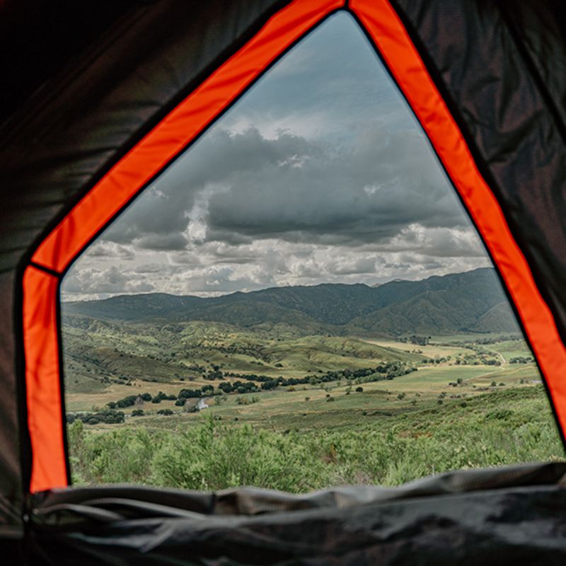 Badass Tents "RUGGED" Rooftop Tent (Universal Fit).View inside looking out of window of open tent. on vehicle