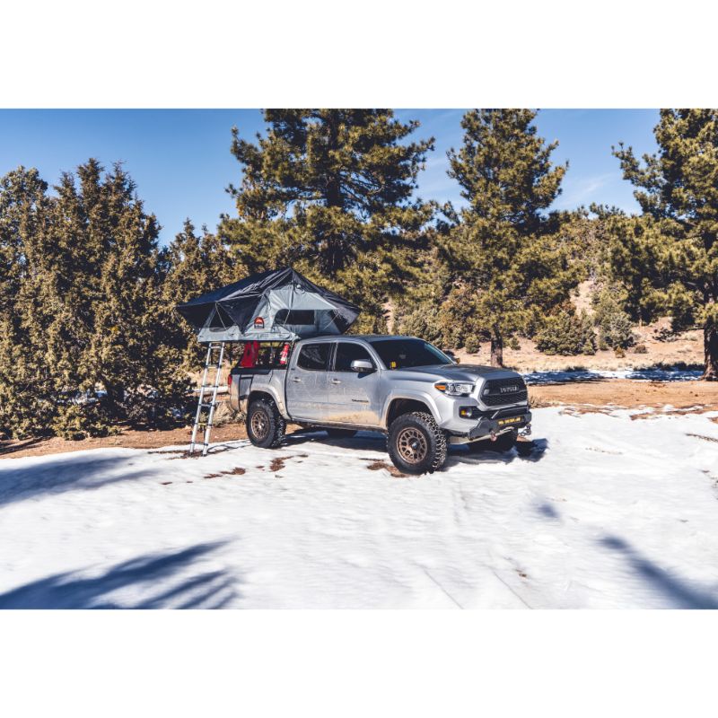 Body Armor 4X4 Sky Ridge Pike Soft Shell Rooftop Tent (2 Person). Left view of open tent with ladder on truck on white background