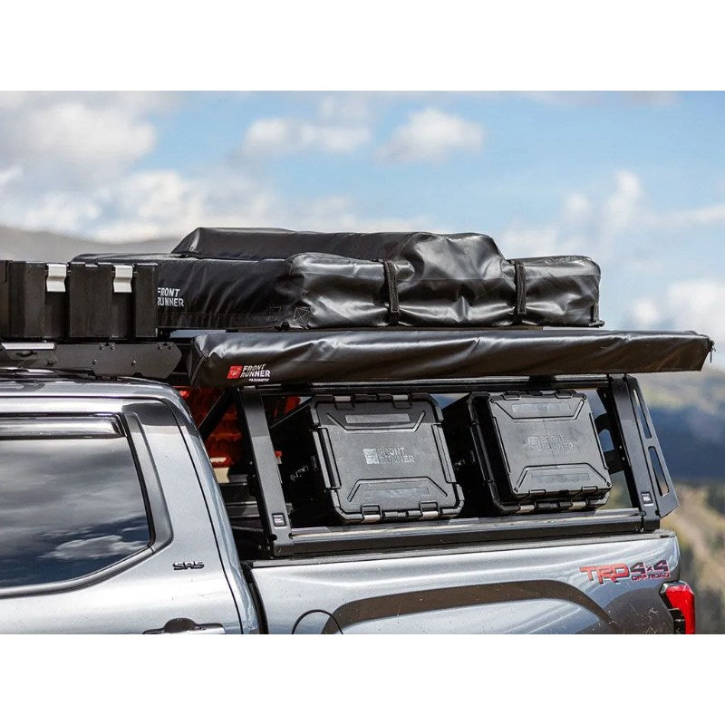 Front Runner Pro Bed Rack Kit for Toyota Tundra (3rd Gen) 4 Door Crew Max 5.5' (2022-Current) side view on truck with gear outdoors