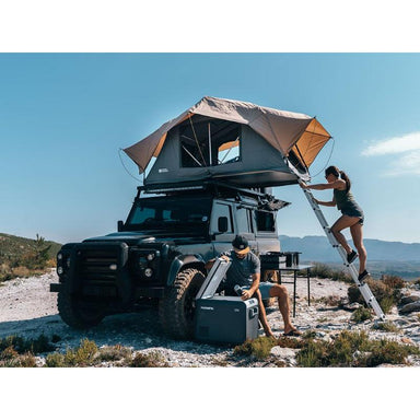 front runner rooftop tent in use with lady on ladder