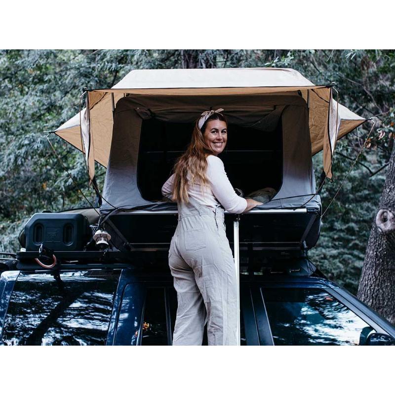 front runner rooftop tent open with lady climbing in