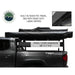 Overland Vehicle Systems Nomadic Awning 180 - Dark Gray With Black Cover side view on vehicle closed on white background