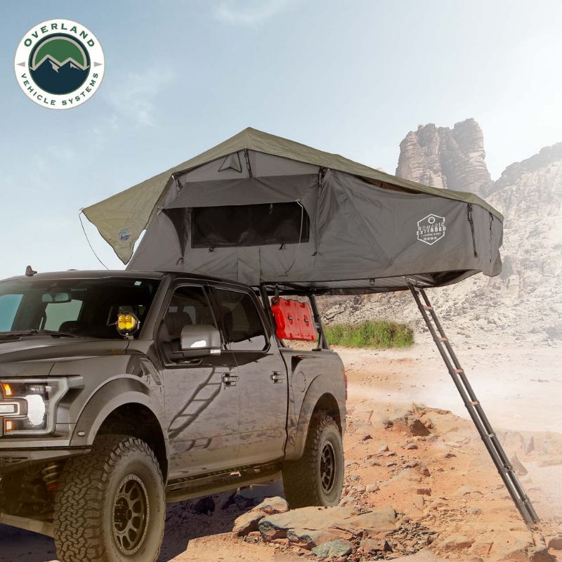 Overland Vehicle Systems Nomadic 2 Extended Roof Top Tent Open tent outside on truck with ladder