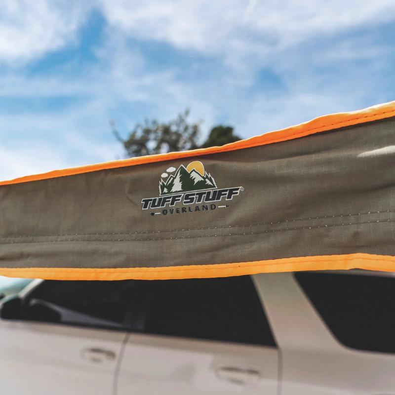 Tuff Stuff Overland 180 Degree Awning, XL, Driver or Passenger Side, C-Channel Aluminum, Olive close up of logo on vehicle outdoors