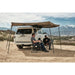 Tuff Stuff Overland 270 Degree Awning, Compact, Driver Side, C-Channel Aluminum, Olive open on vehicle outdoors with people