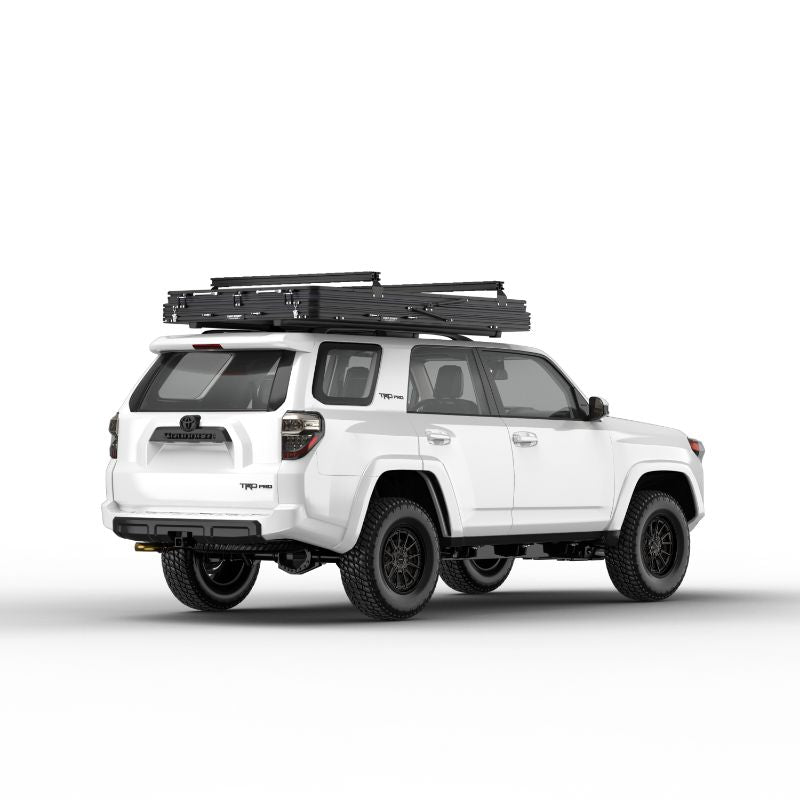 Tuff Stuff Overland Alpine 51 Hard Shell (Aluminum) Roof Top Tent. Rear corner view of closed tent with ladder on truck on white background