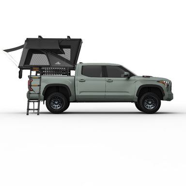 Tuff Stuff Overland Alpine 61 Hard Shell (Aluminum) Rooftop Tent. Side view of open tent with ladder on truck on white background