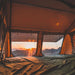 Tuff Stuff Overland Elite Soft Shell Rooftop Tent & Annex Room (5 Person). View from inside tent looking out at sunset through two windows