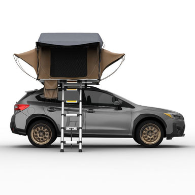Tuff Stuff Overland Trailhead Soft Shell Rooftop Tent (2 Person). Side view of open tent with ladder on vehicle on white background.