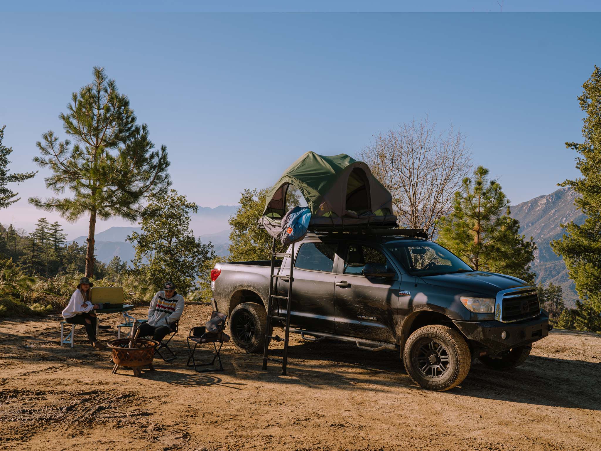 Rev Platform x SCOUT DESERT FOREST on truck with ladder and people at campsite