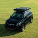 Trustmade Scout Pro Series - Triangular Hard Shell Rooftop Tent closed on vehicle on grass