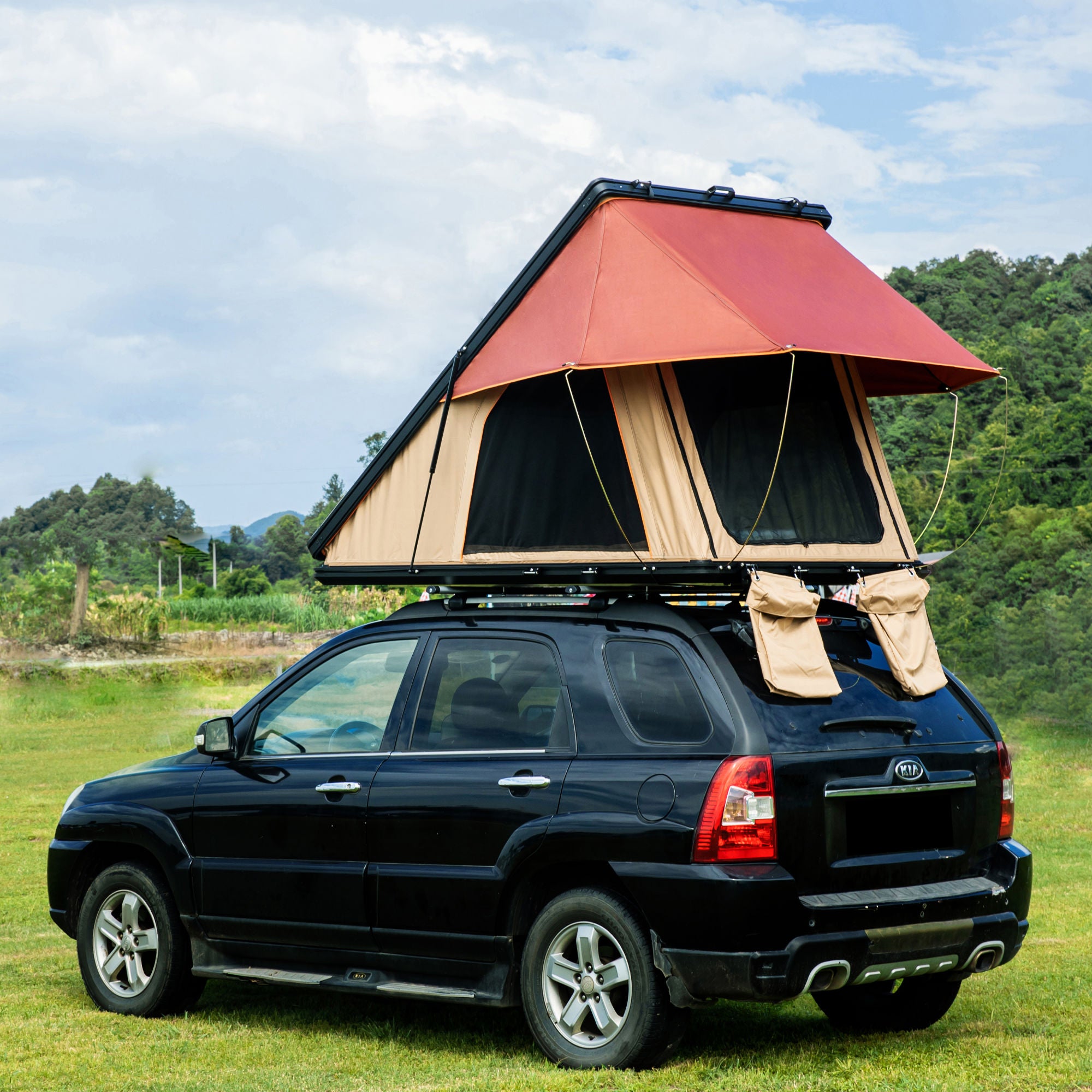 Trustmade Scout MAX Series - Triangular Hard Shell Rooftop Tent assembled on suv outside on grass