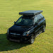 Trustmade Scout MAX Series - Triangular Hard Shell Rooftop Tent disassembled on suv outside