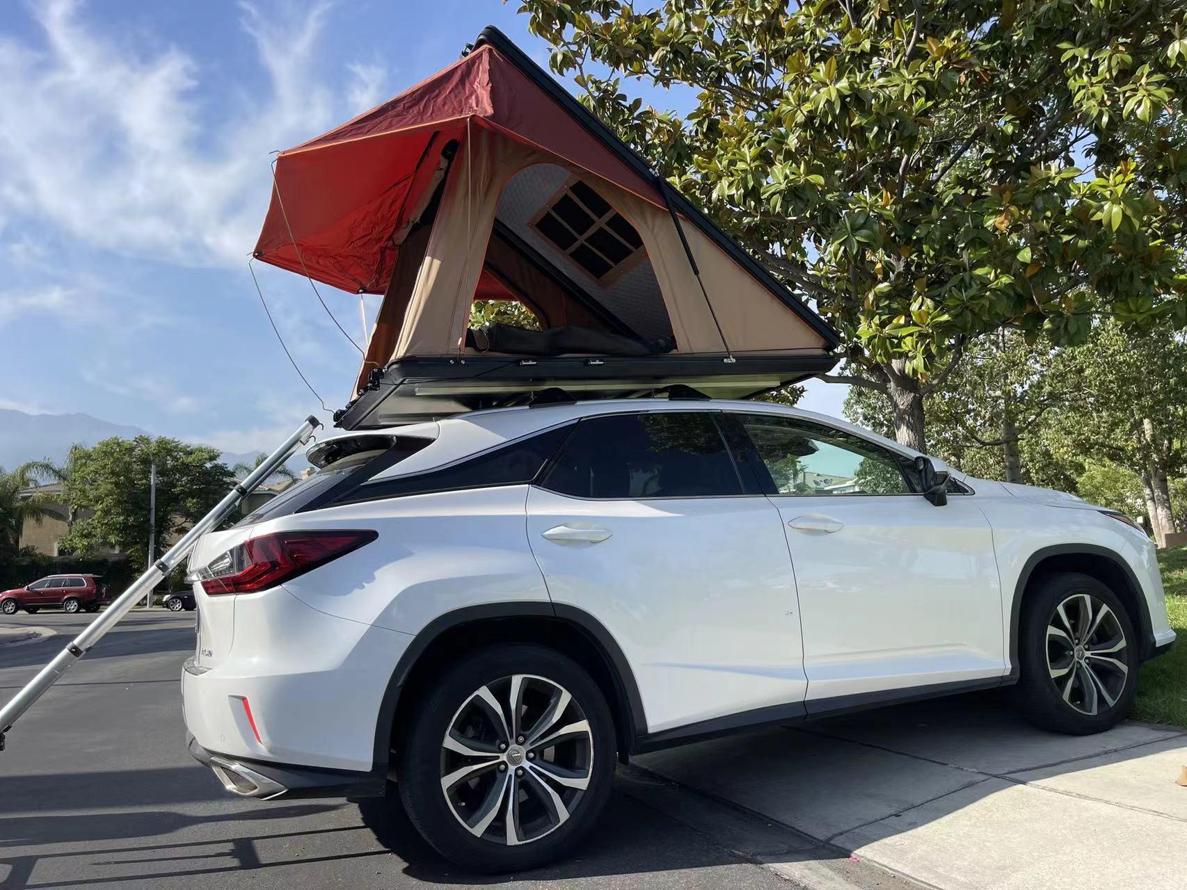 Trustmade Scout MAX Series - Triangular Hard Shell Rooftop Tent assembled on suv with ladder in parking lot side view