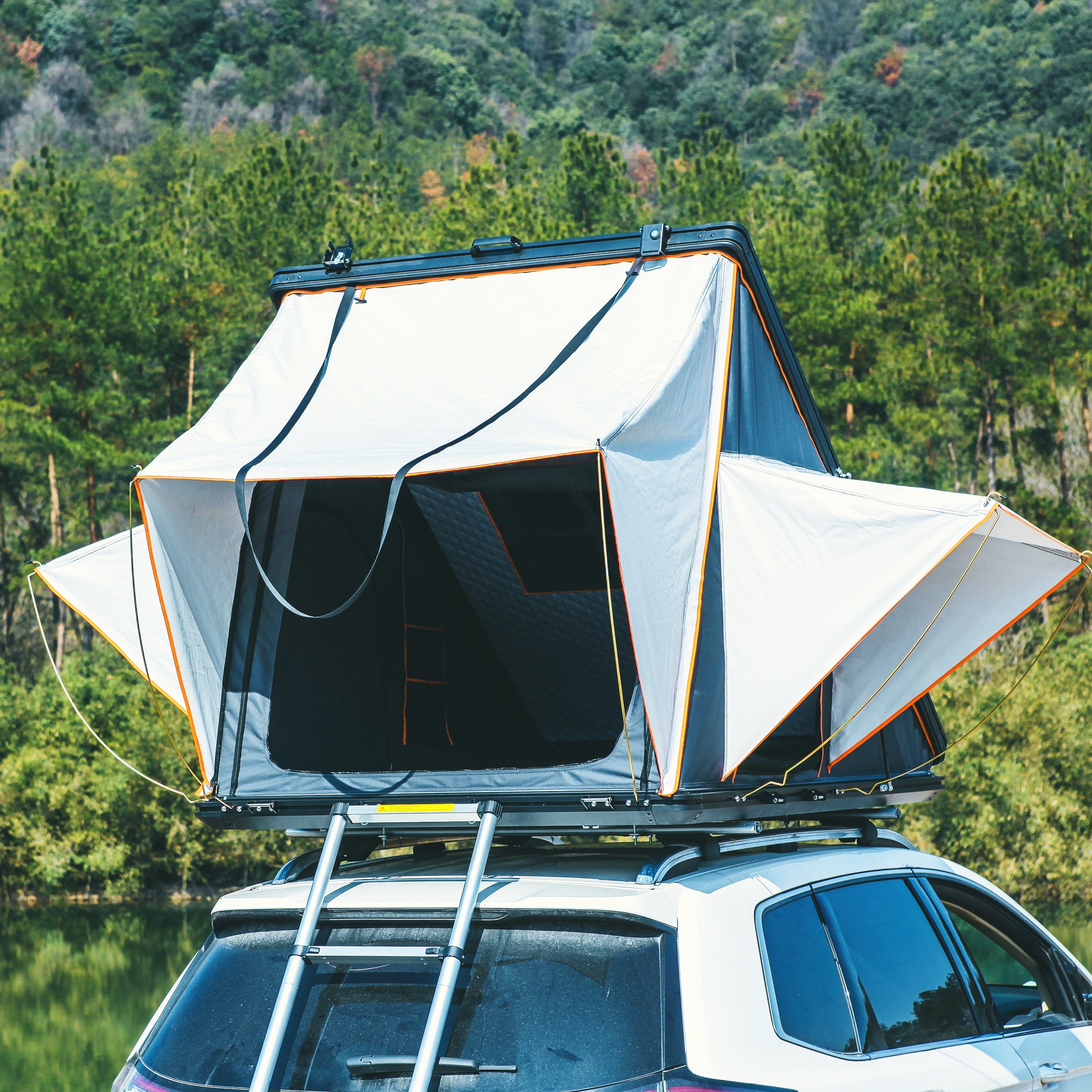 Trustmade Scout Pro Series - Triangular Hard Shell Rooftop Tent open outdoors on vehicle