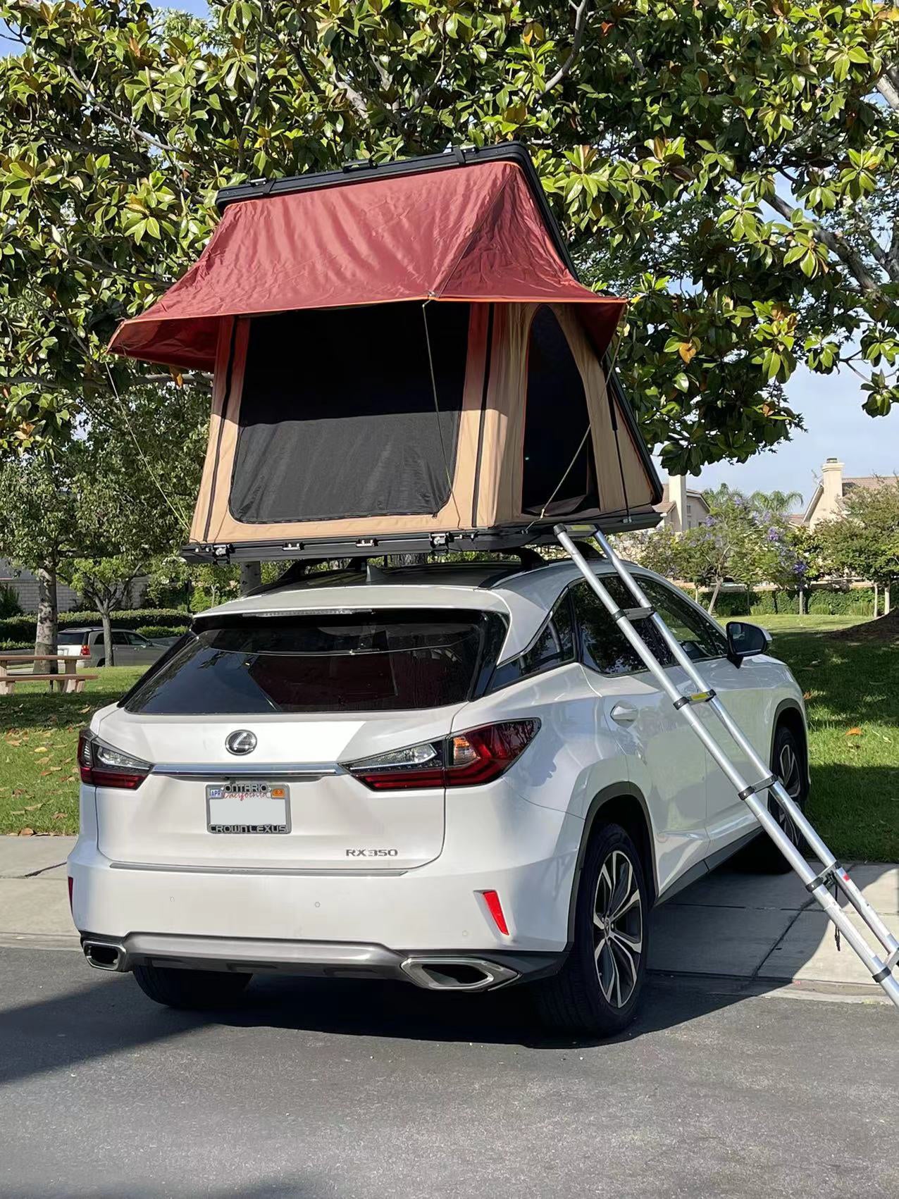 Trustmade Scout MAX Series - Triangular Hard Shell Rooftop Tent assembled on suv with ladder in parking lot