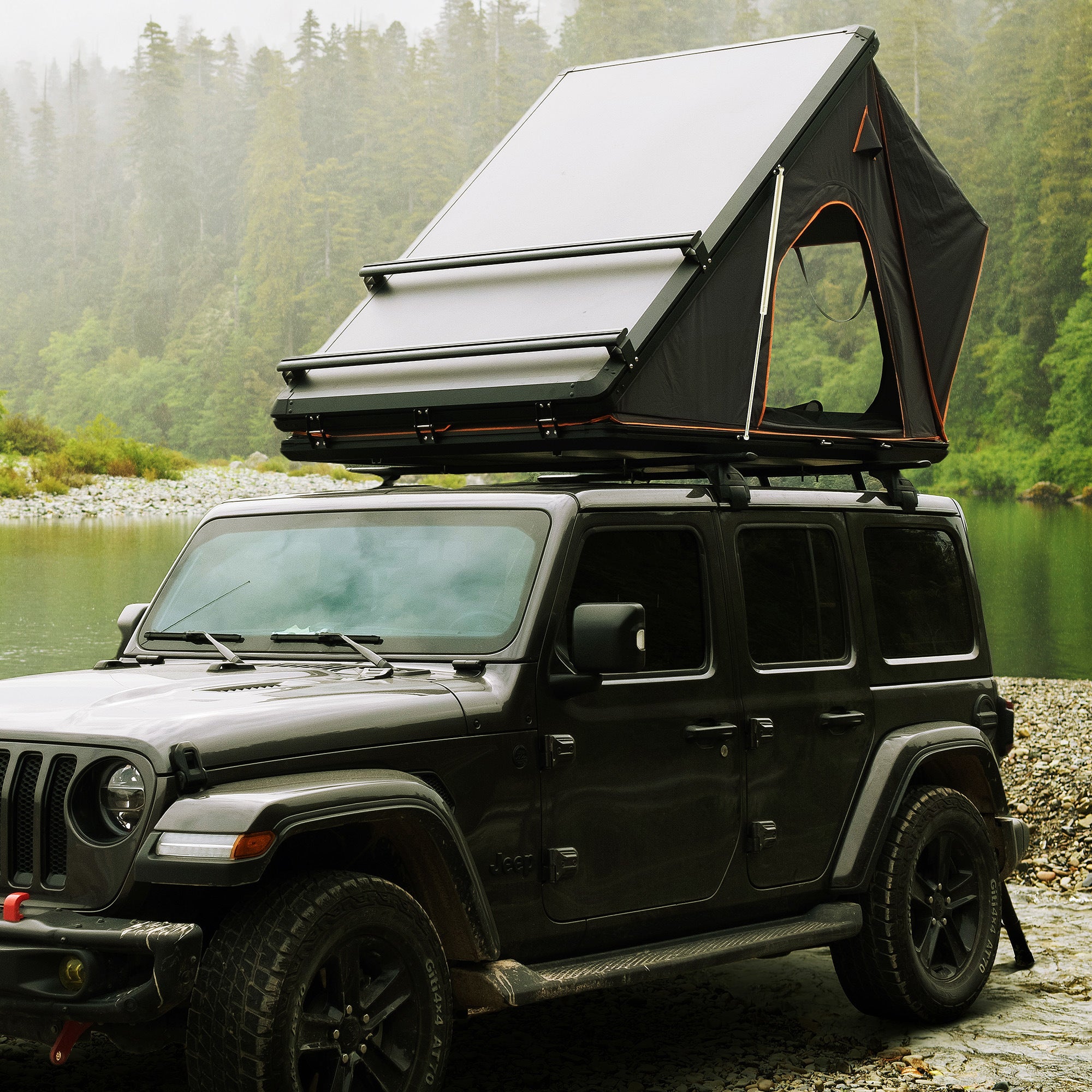 Trustmade Scout Plus Series - Triangular Hard Shell Rooftop Tent with Roof Rack assembled on truck with ladder at lake front view