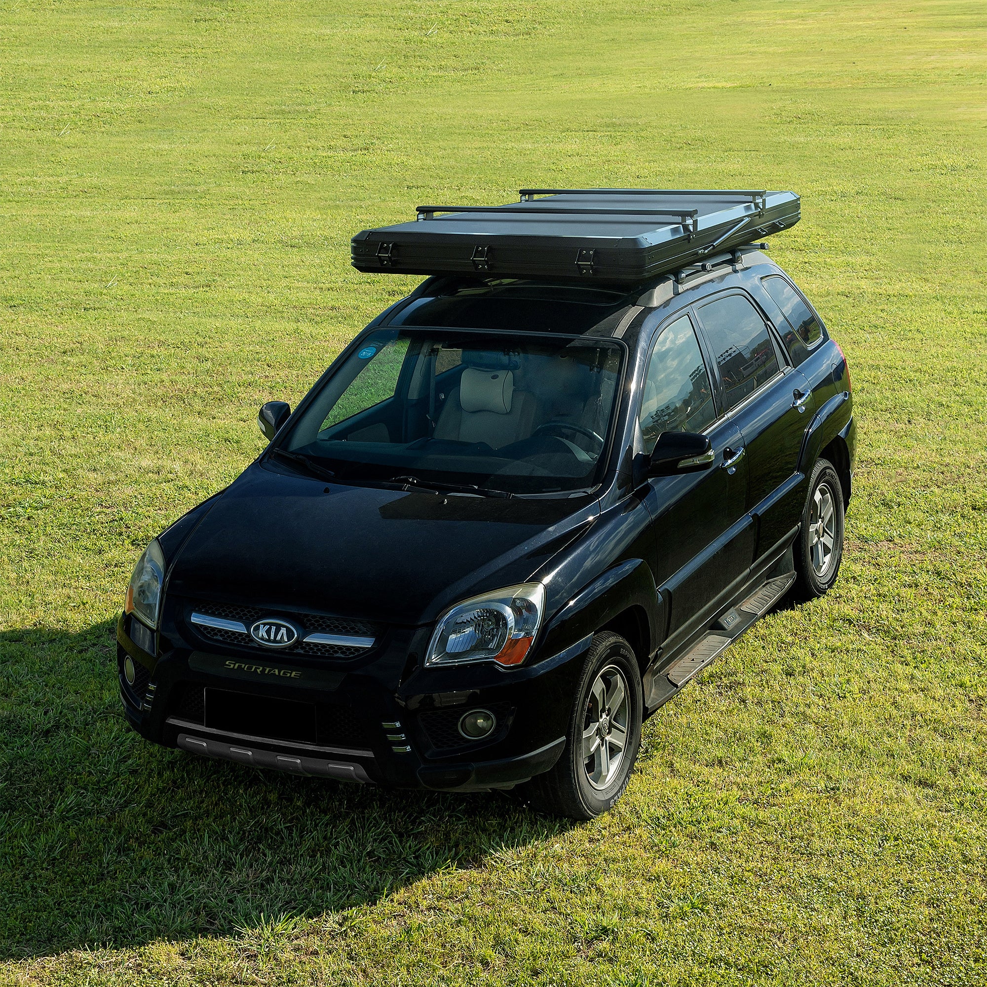 Trustmade Scout MAX Series - Triangular Hard Shell Rooftop Tent closed on suv on grass